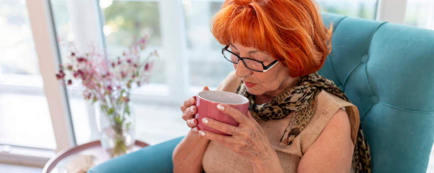 Elderly Woman sitting with a cup of tea