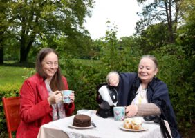 Mother and Daughter sitting in the garden having tea with their Uccello Kettle