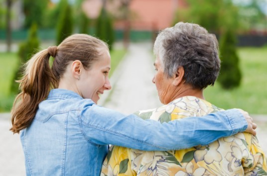 Young woman caring for elderly woman