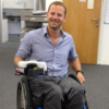 Wheelchair User using the Muggi Cup Holder