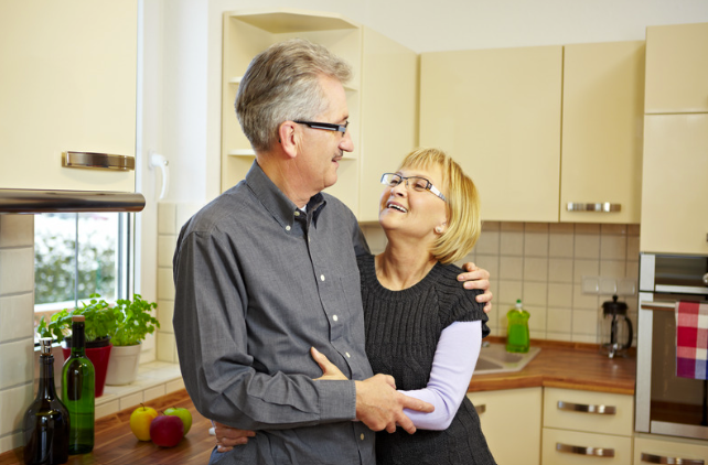 Caring Wife hugs her husband in the kitchen