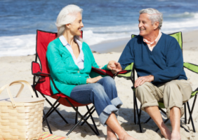 Elderly couple sitting on the beach