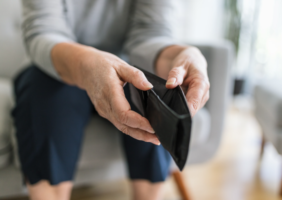 Elderly woman with an empty purse