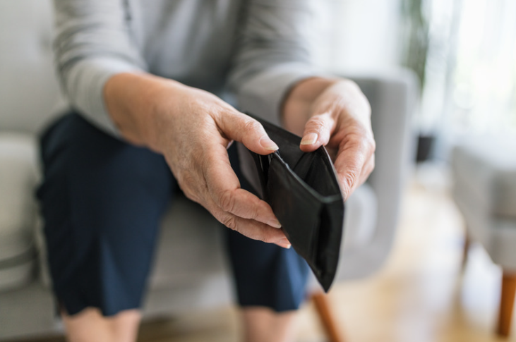 Elderly woman with an empty purse