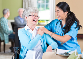 Nurse taking care of elderly woman in a wheelchair