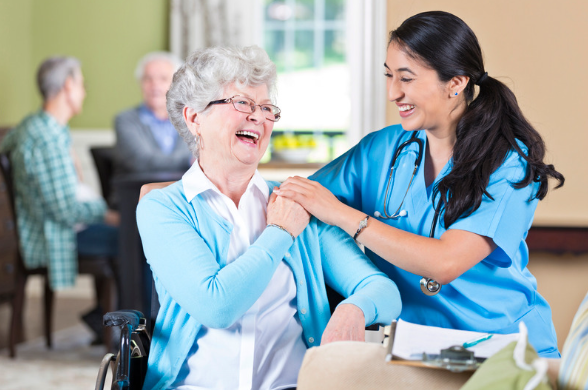 Nurse taking care of elderly woman in a wheelchair