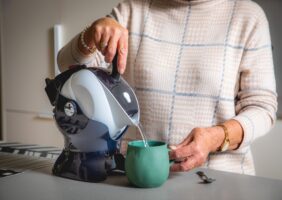 Elderly woman with Uccello Easy Pour Kettle making a cup of tea