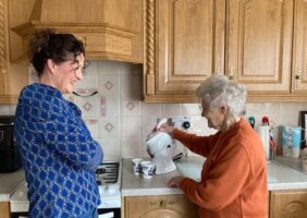 Mother and daughter in the kitchen making tea with the all white Uccello Kettle